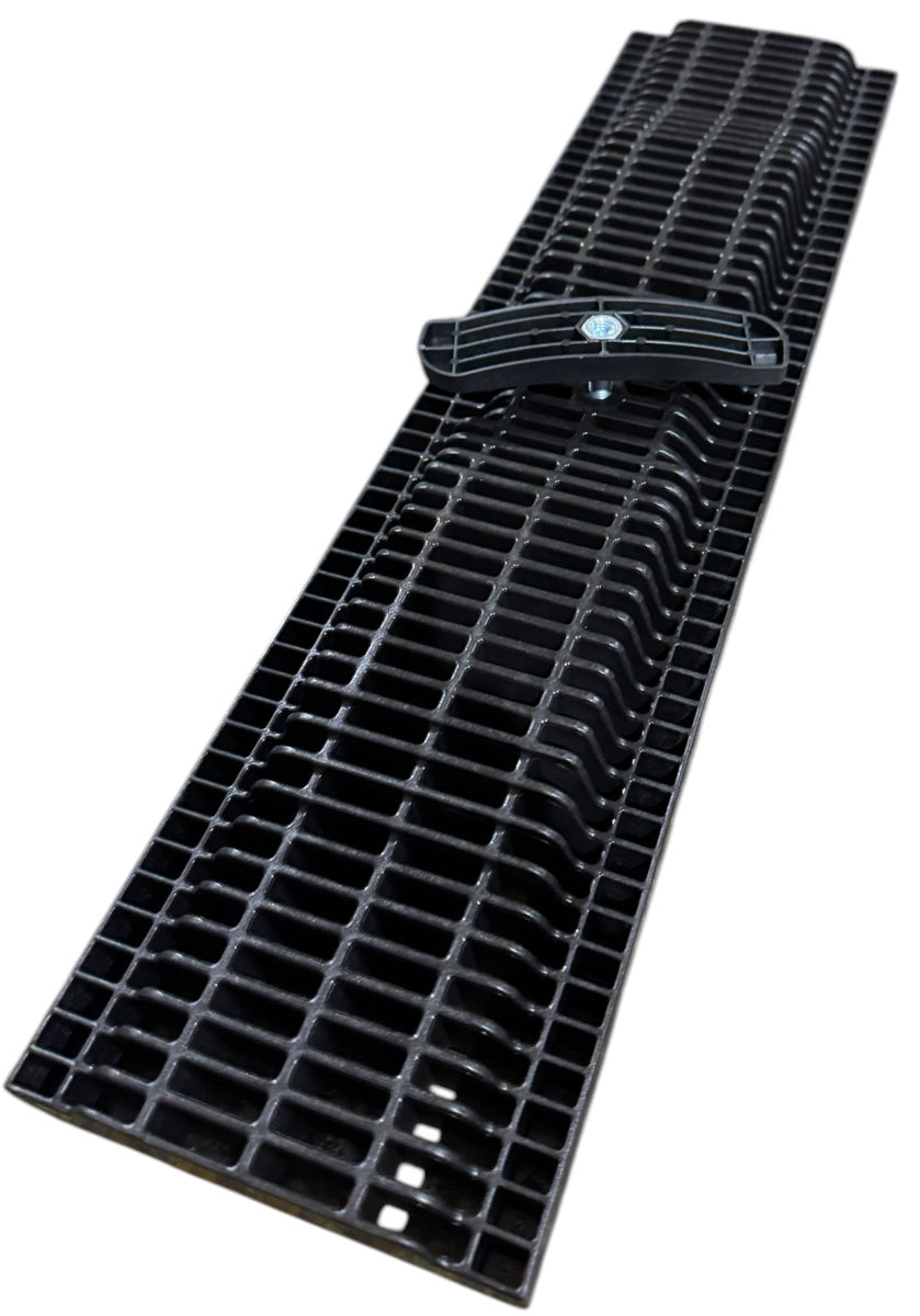 A top-down view of the channel drain's slotted grate, with a small black attachment.