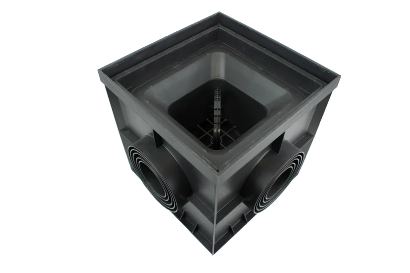 A black plastic square-shaped box with circular intake ports on the sides and a central vertical component, shown on a plain white background.