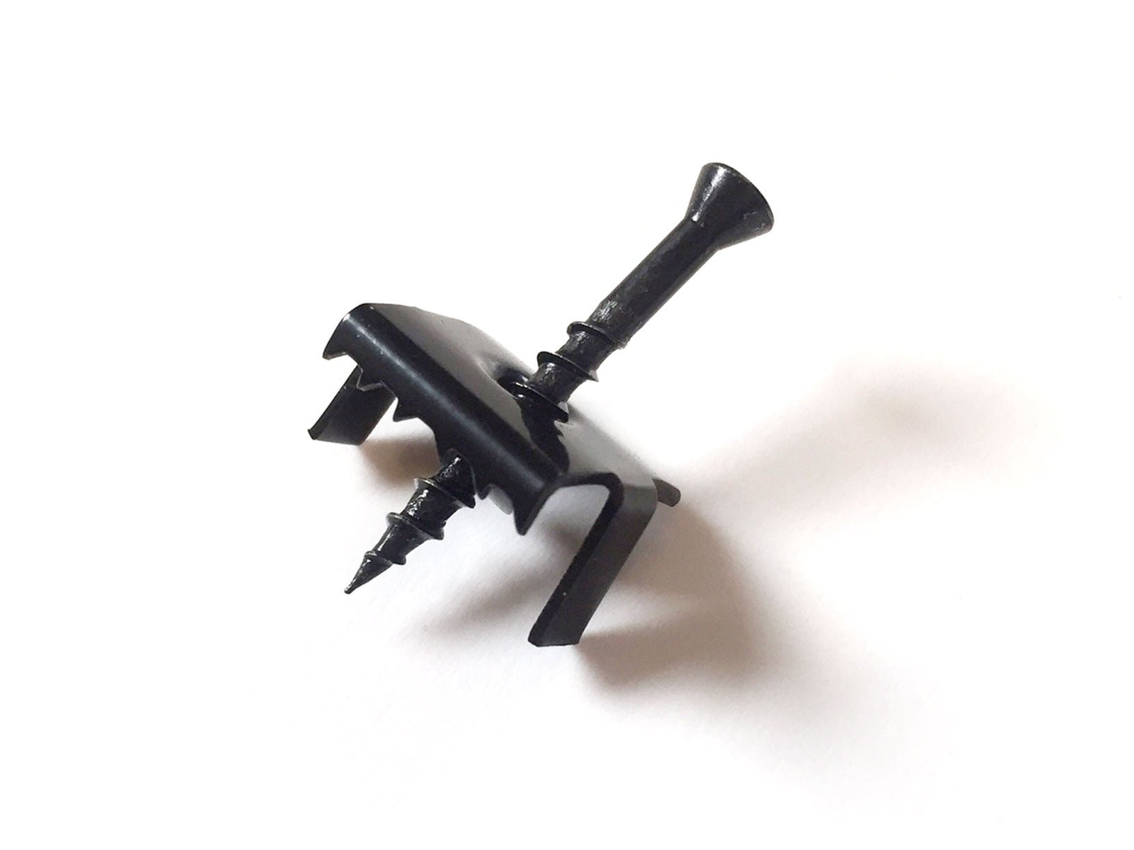 Black TC1 hidden fastener for composite decking, with an integrated screw, against a plain white background.