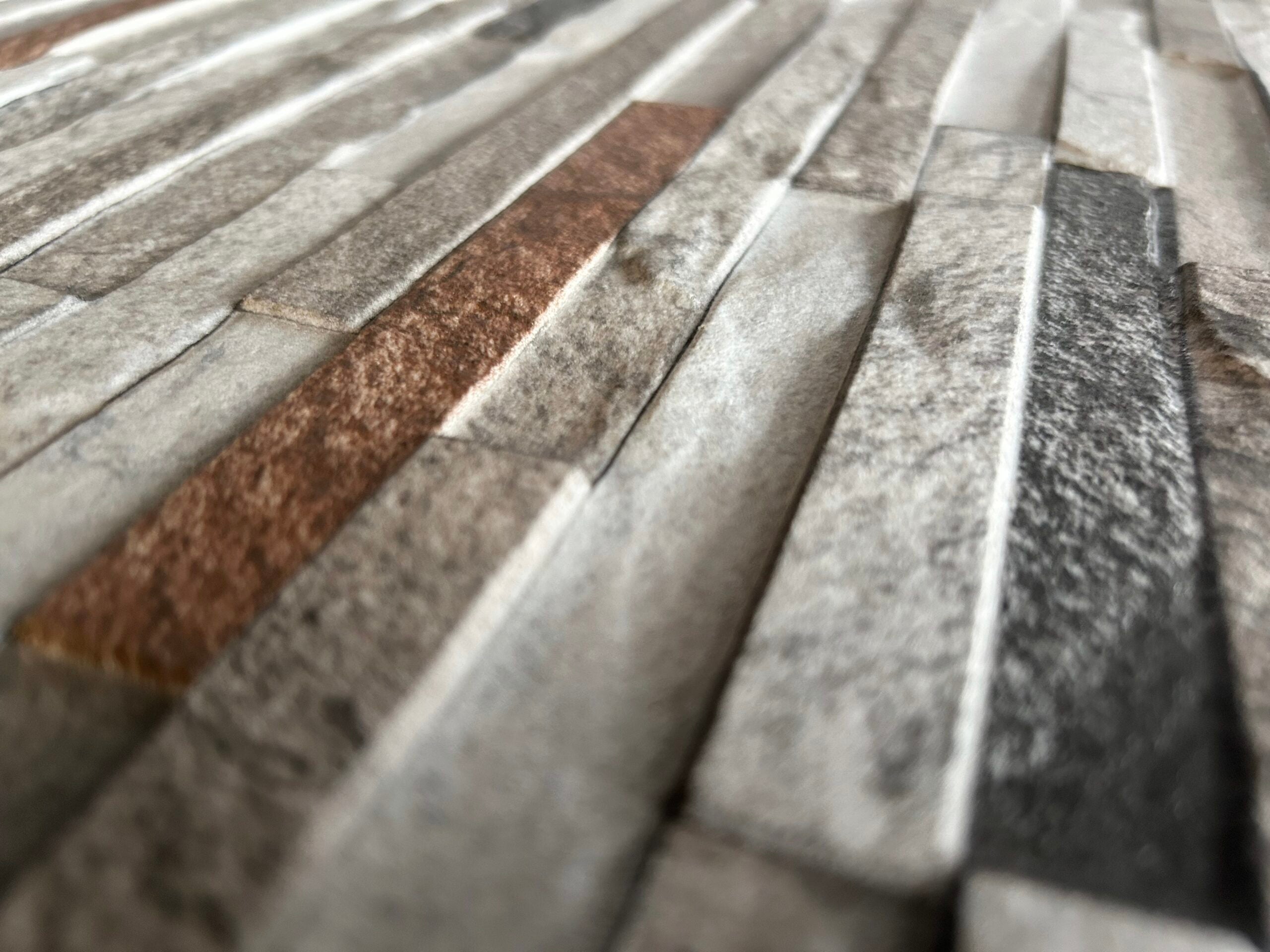 Detailed view of textured Ash Rose composite wall cladding.